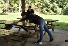 students cleaning picnic tables