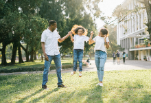 Father and Mother lifting up child playfully