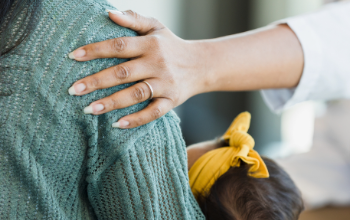 Helping hand holding on to parent arm