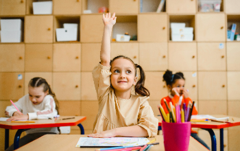 Girl raising her hand in a classroom