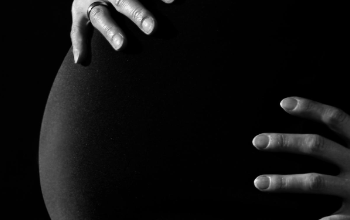 Mother touching pregnant belly