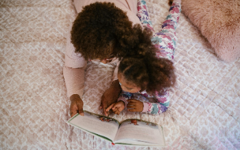 Overhead Image of Mom and Daughter Reading Together