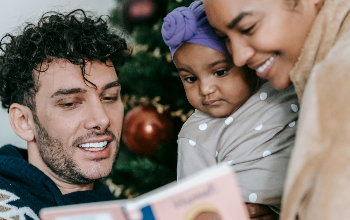 Parents reading to daughter