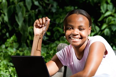 Smiling girl with a laptop